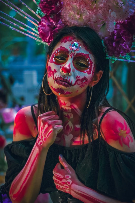 a woman with makeup painted pink, red and white