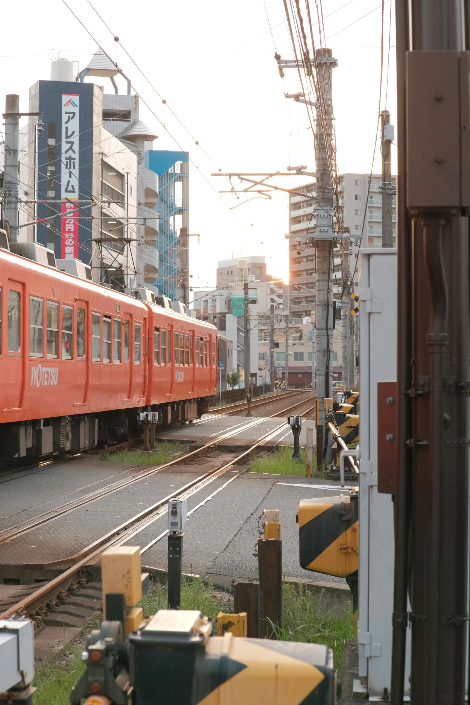 a train traveling down tracks near tall buildings