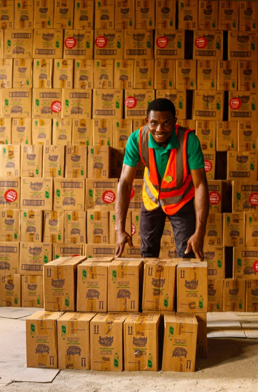 man standing over stacks of boxes on sidewalk