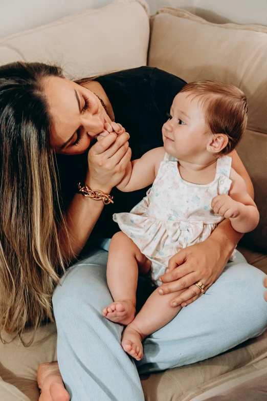 a woman holding her baby and laughing