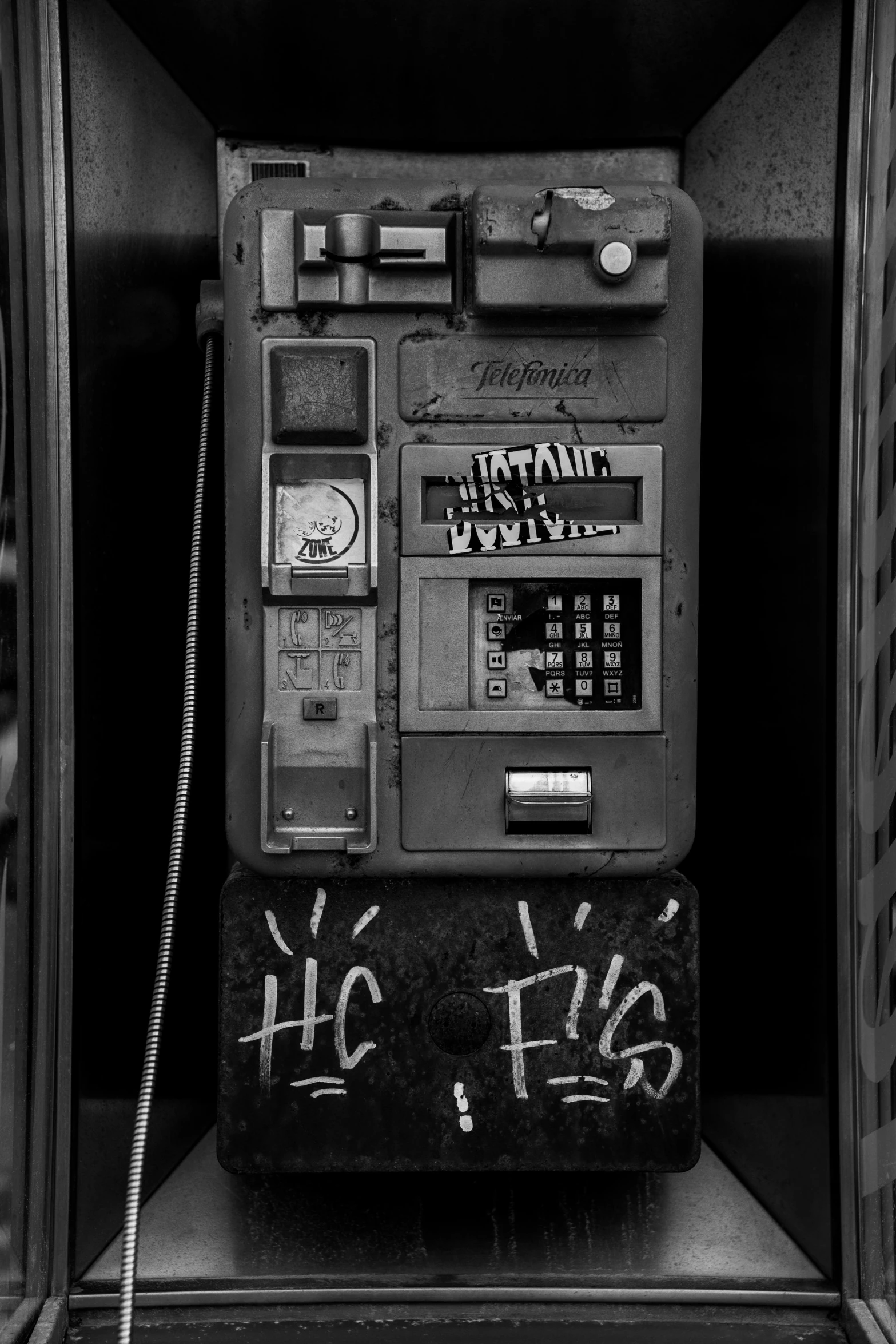 a machine that is written with graffiti inside of a storage bin