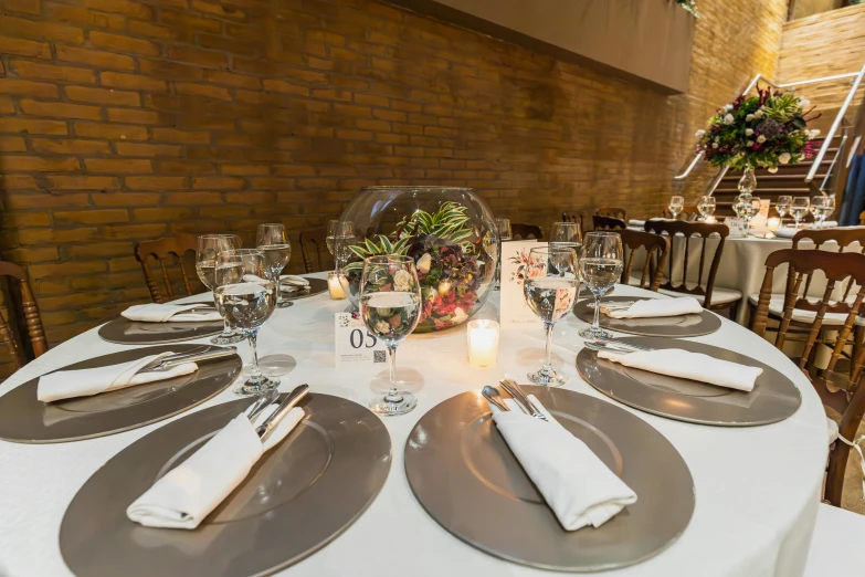 a dining table with place settings is set