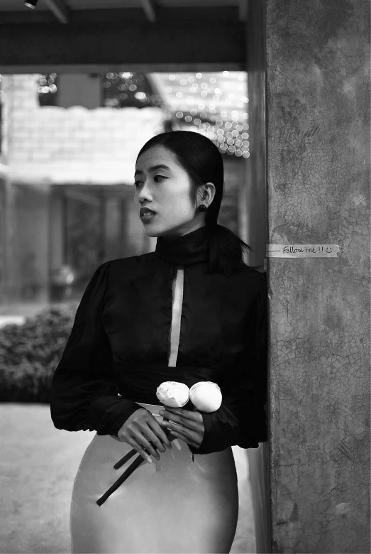 a young asian woman is posing in a black and white po