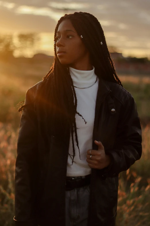 the woman is wearing dreadlocks with her hair up