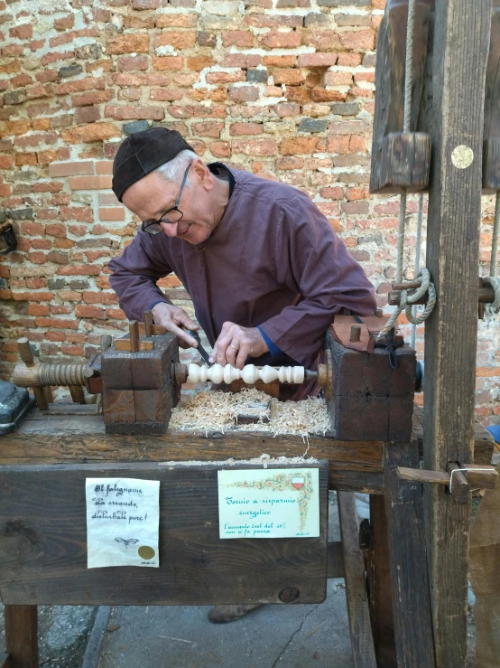 a man works on soing using an old fashioned machine