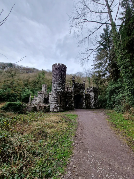 a stone building that is sitting on a trail