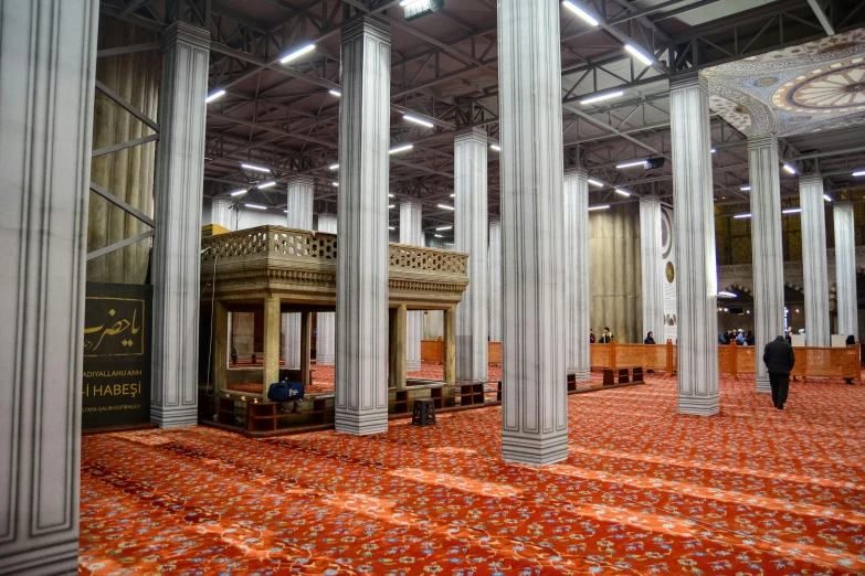 an inside view of a building with columns and seats