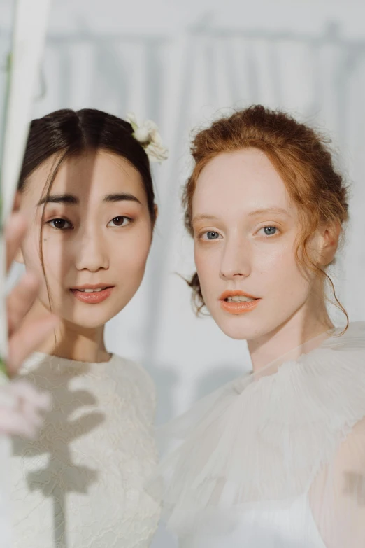 two models with peach lips and hair with makeup on