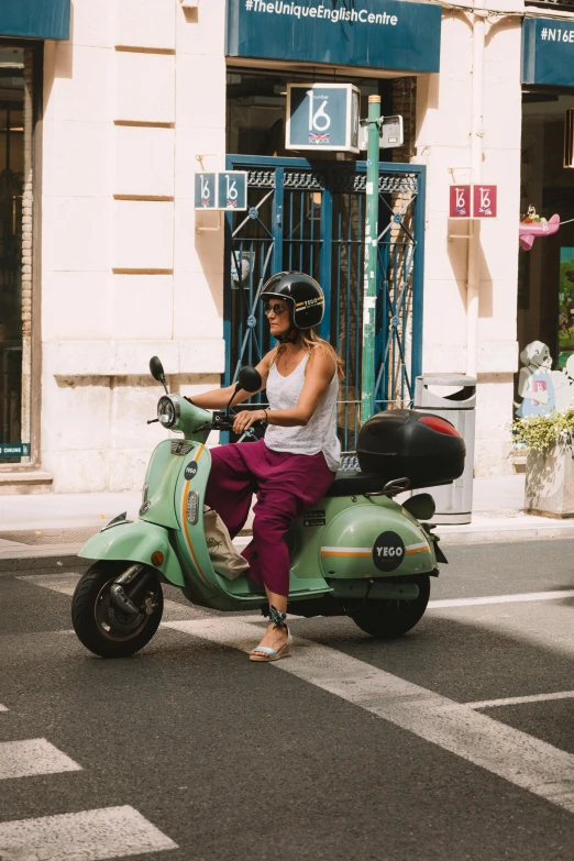 a person that is riding on a motor scooter