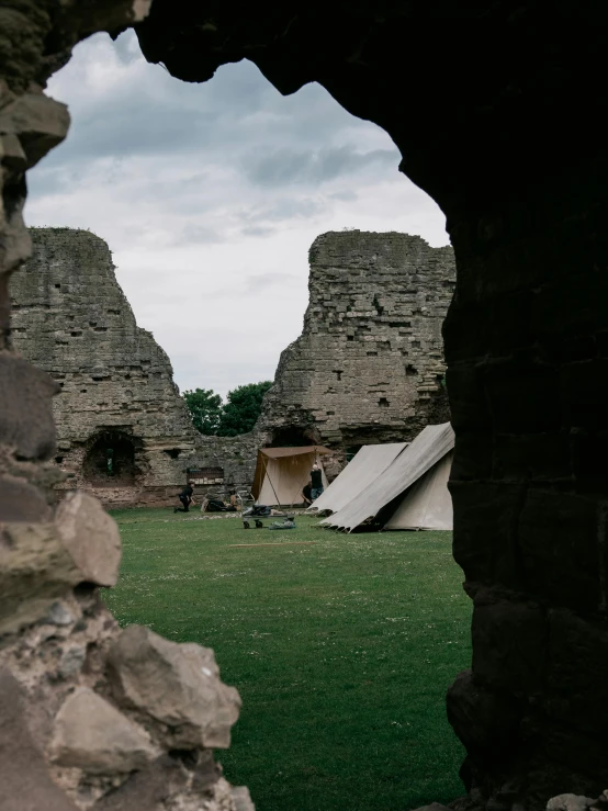 there is an arched window in the stone structure