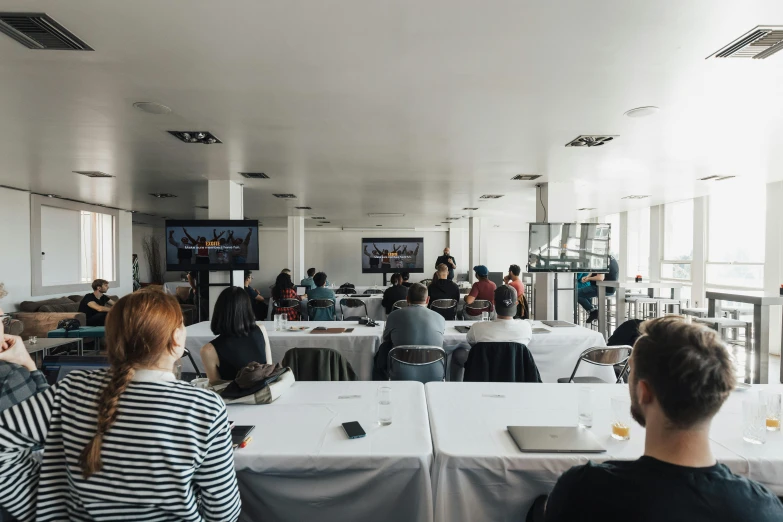 a group of people sit at a long table together