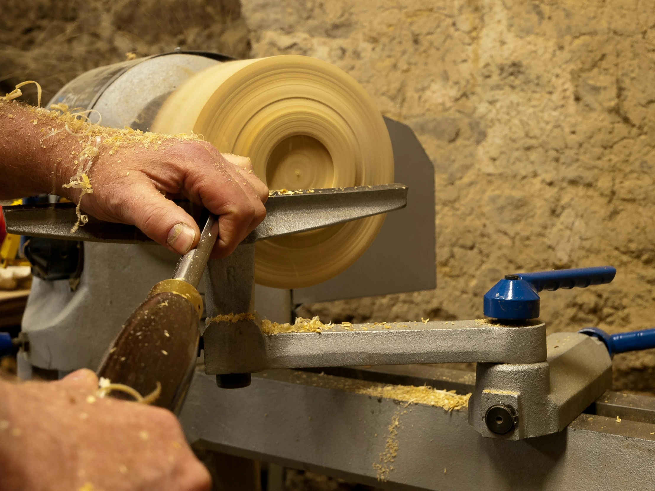 a person is carving the parts of a piece with their hand