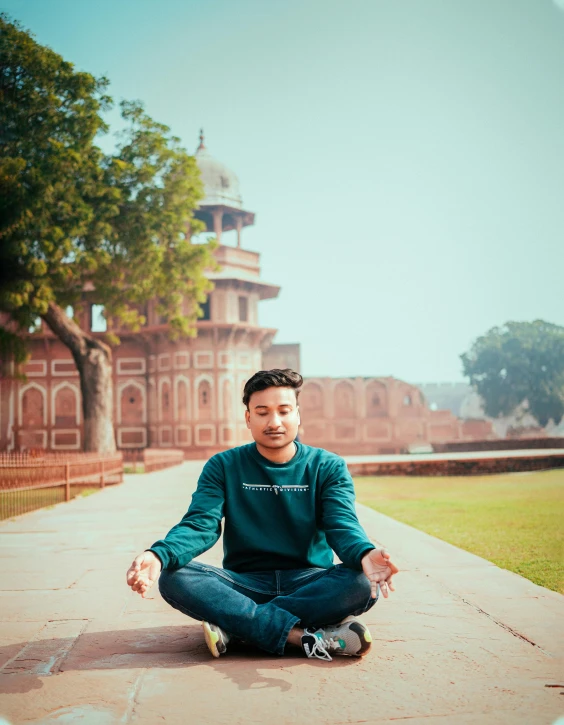 a man that is sitting in the grass