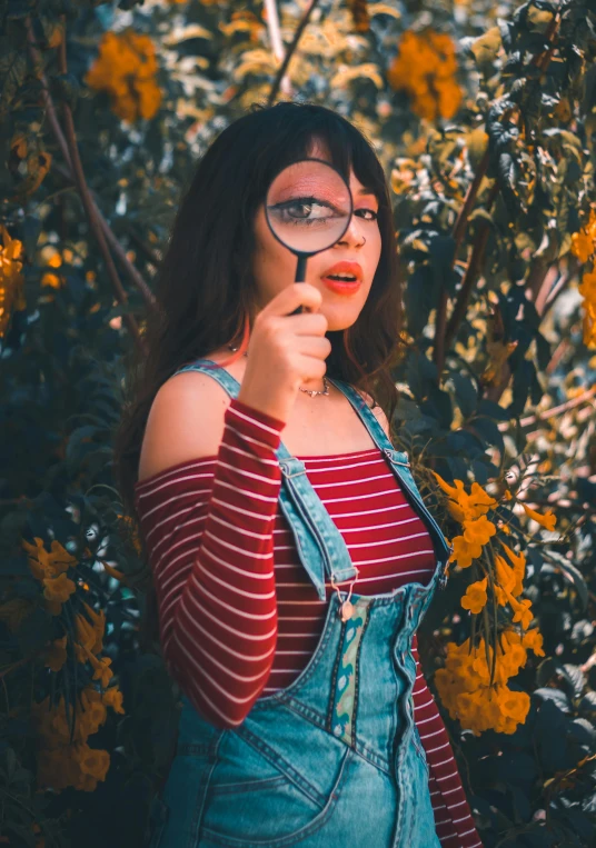 a woman with glasses looks through her magnifying glass