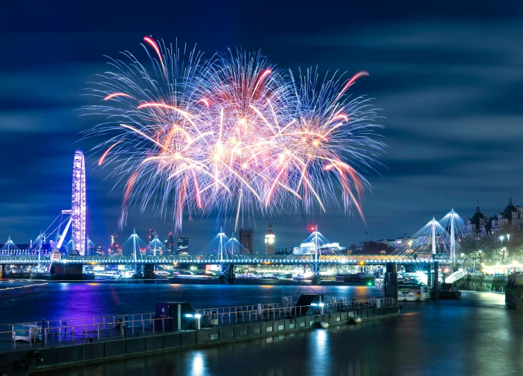a brightly colored fireworks is exploding over a city