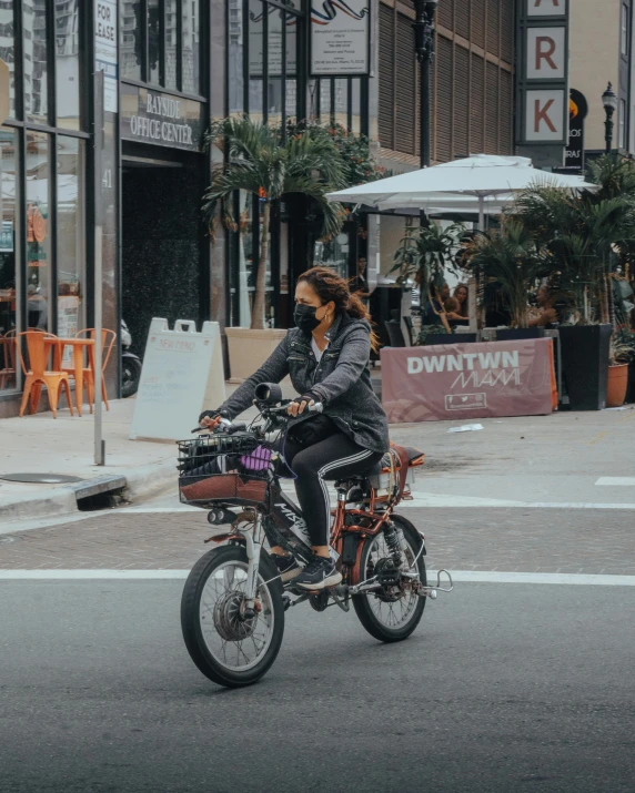 woman on her bicycle riding down the street