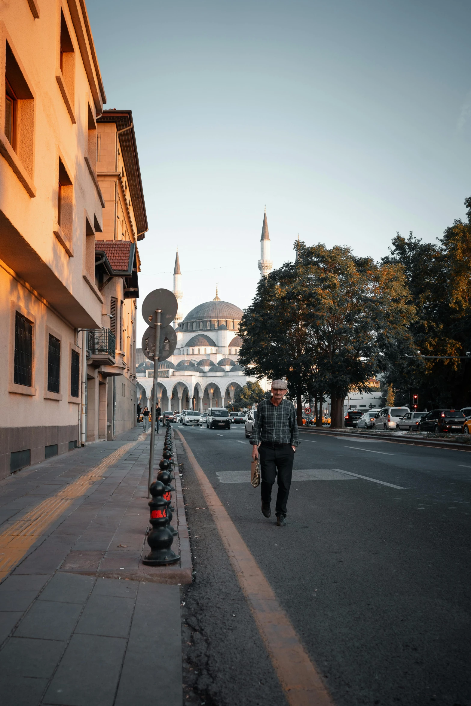 two police officers walk down an empty street in front of a building