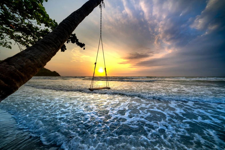 an empty sail boat is docked on the beach