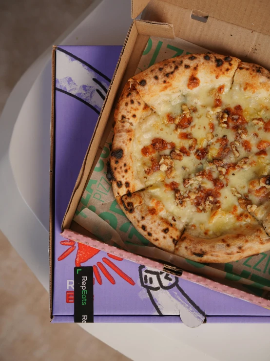 there is a pizza in a box that is sitting on the table