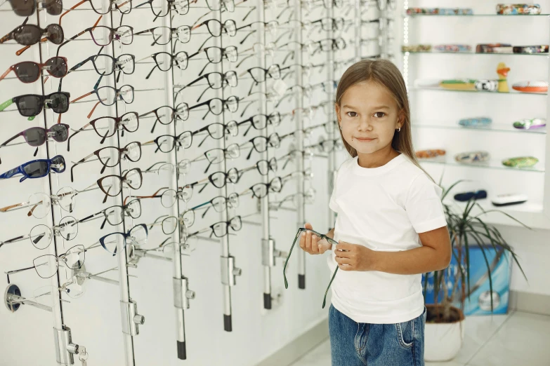  standing in front of an eye chart of glasses