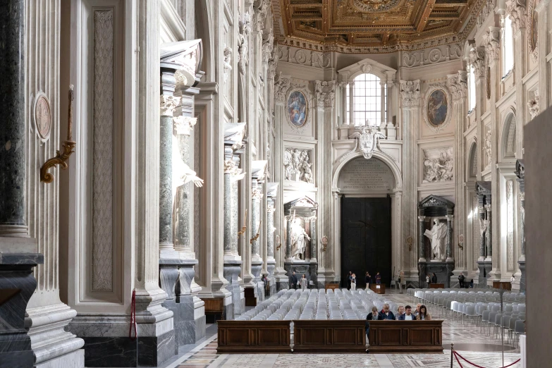 large interior of an old cathedral with lots of pillars