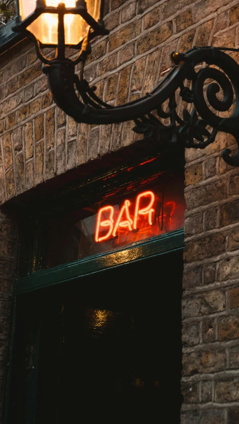 a small bar sign is attached to a wall
