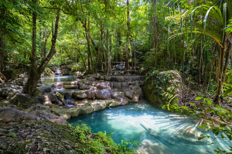 several people relaxing at the top of a waterfall