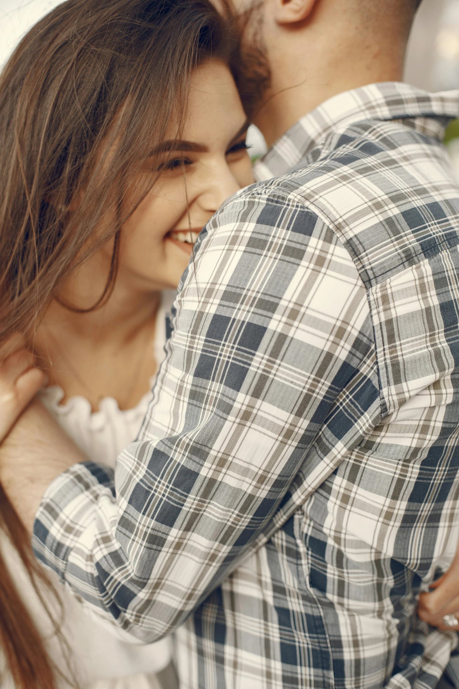 an image of a smiling couple hugging each other