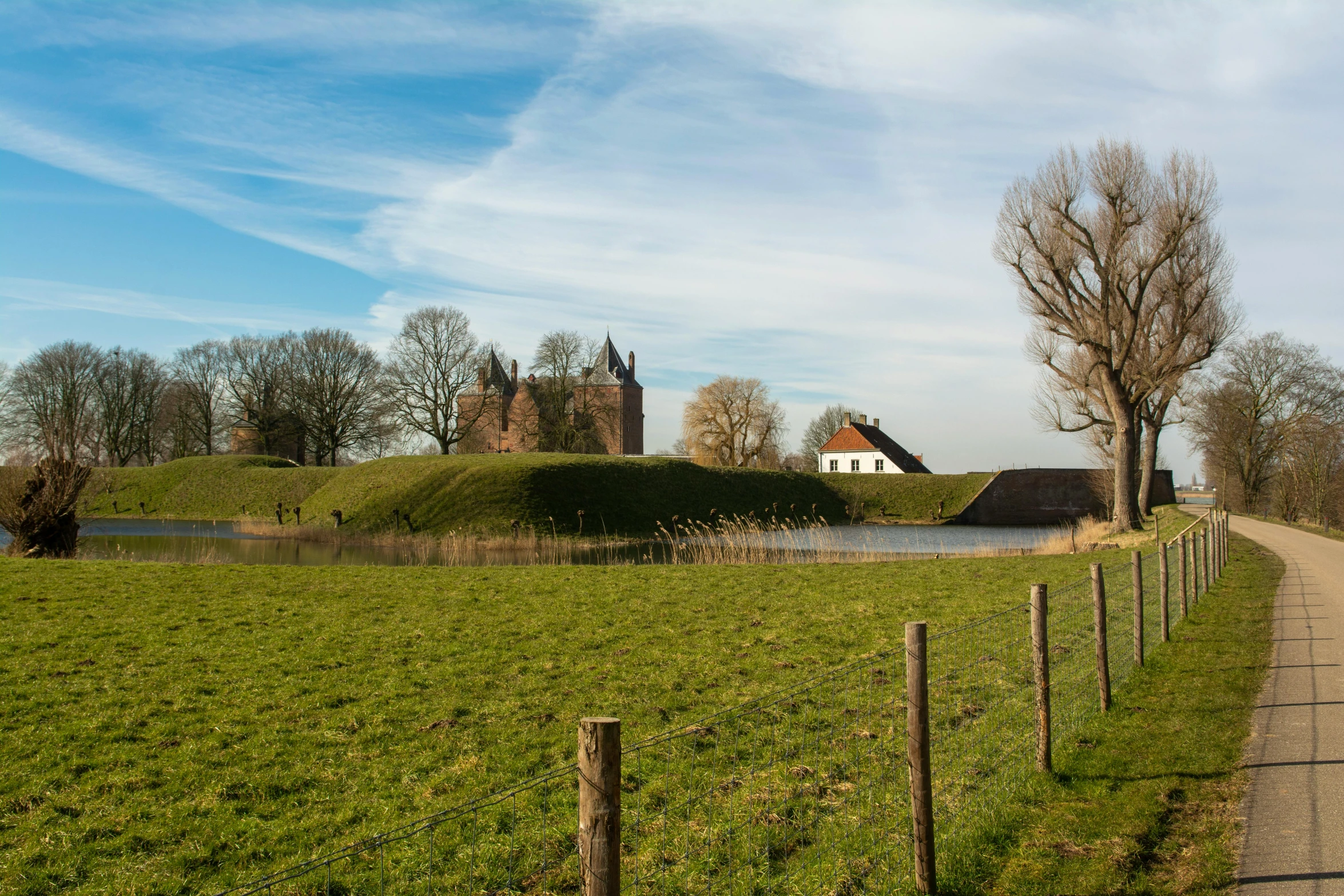 a small rural road on the side of a lake