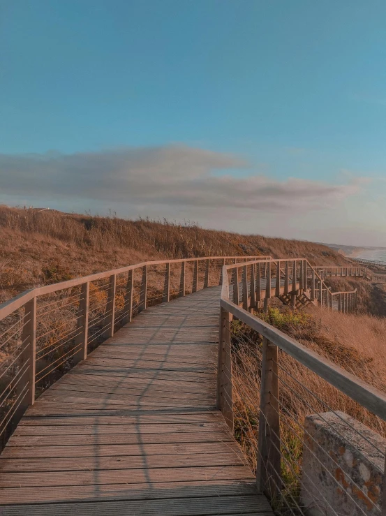 a wooden boardwalk leads out onto the beach