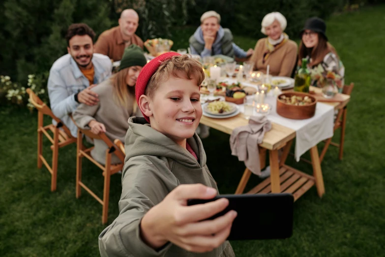 a child with a headband looking at a digital tablet in a group of people