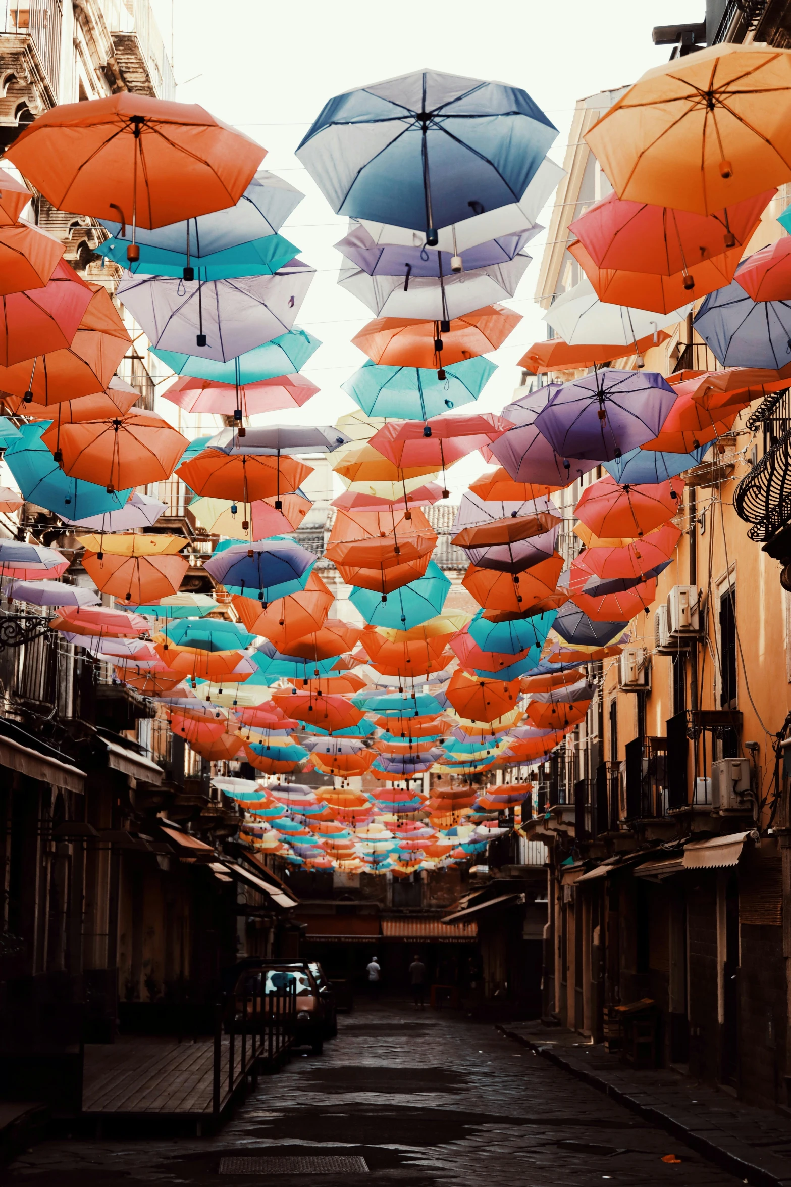 there is a lot of colorful umbrellas in the air