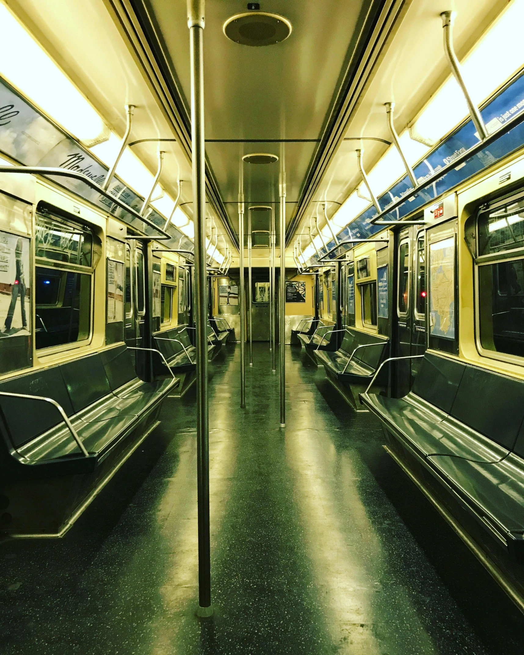 there is a empty metro car that has the lights on