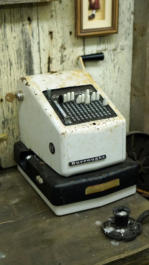 a old typewriter sitting on top of a wooden table