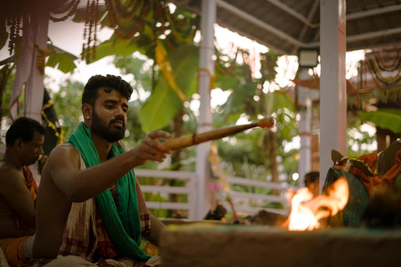 a man holding a long stick above his shoulder