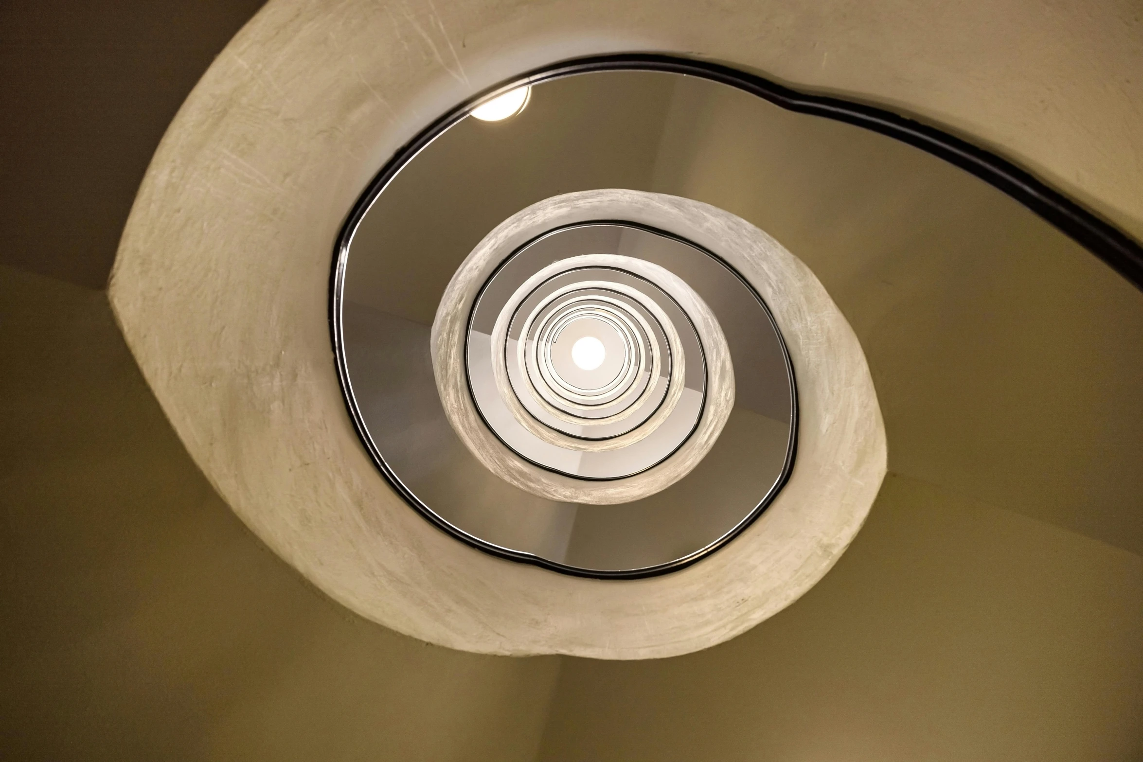 a circular stair case with lights on it