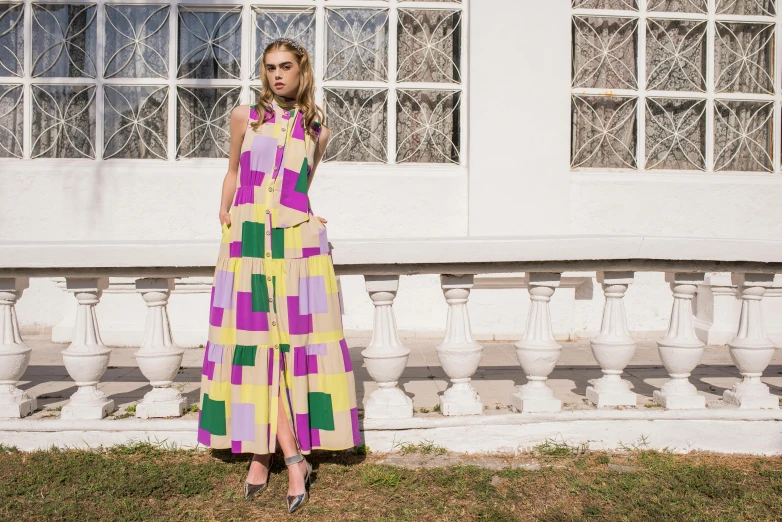 a woman standing outside in a long dress