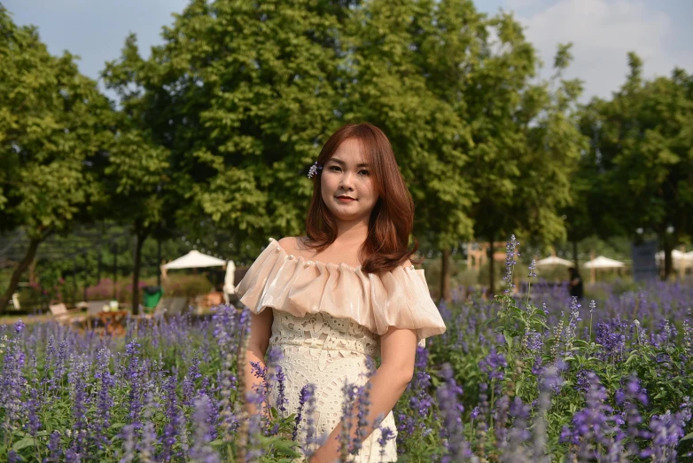 a girl posing in a field with flowers