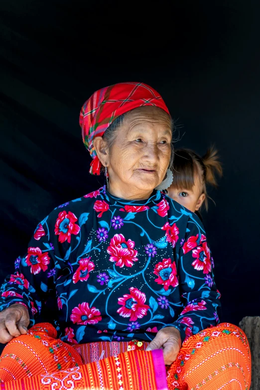 a woman with a bright colored top holding soing in her hands