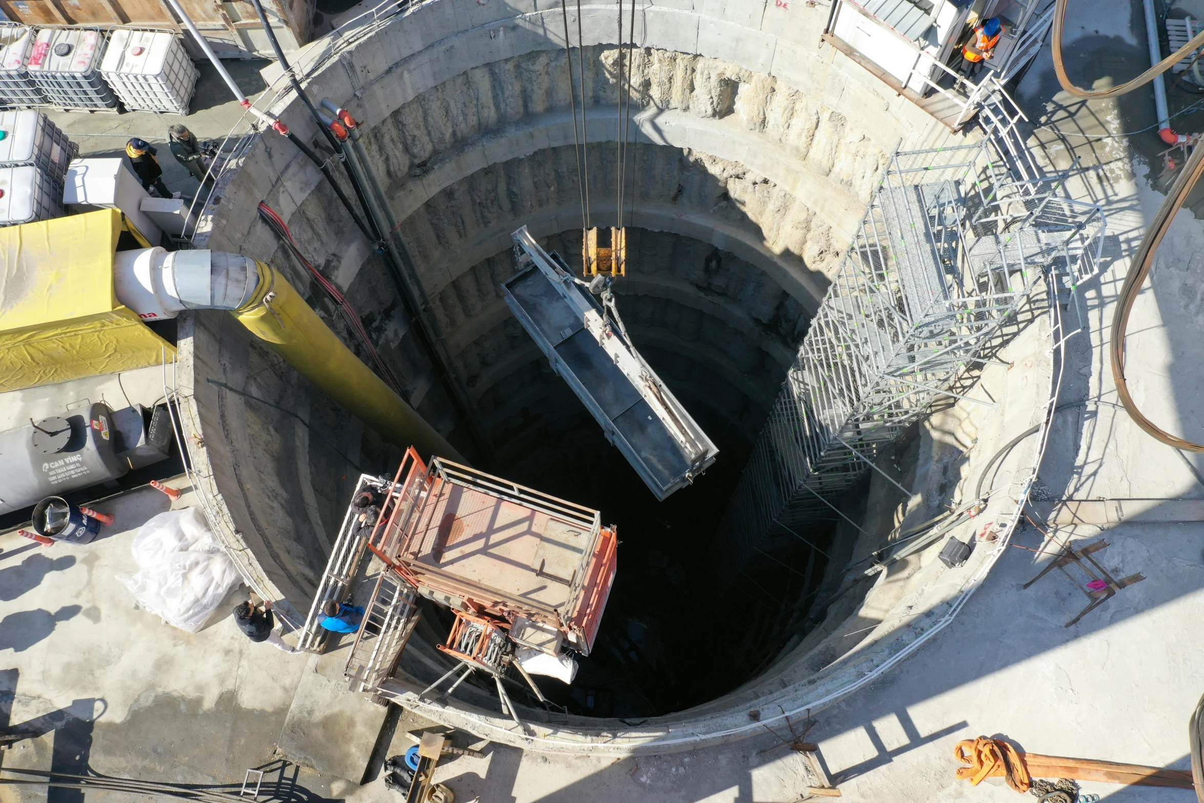 a construction site with large, open pit on top of it