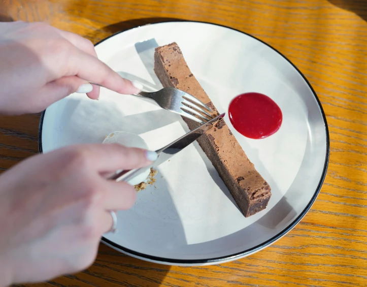 a person is eating some food on a plate