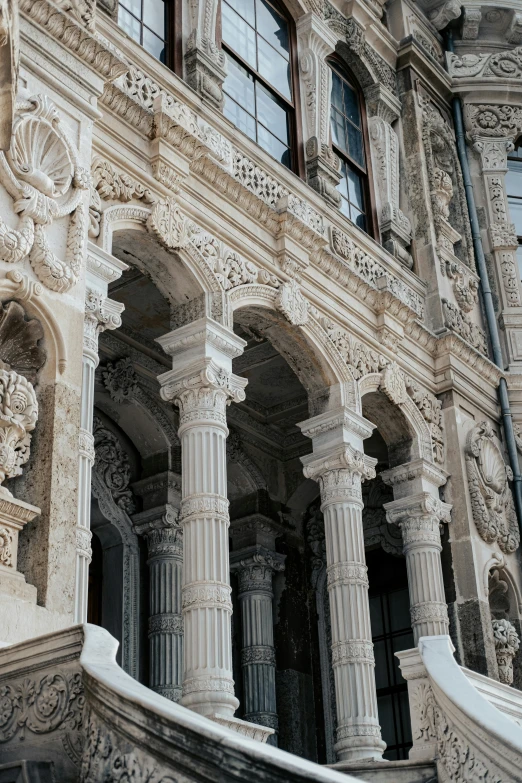 the entrance to a building that has a lot of columns