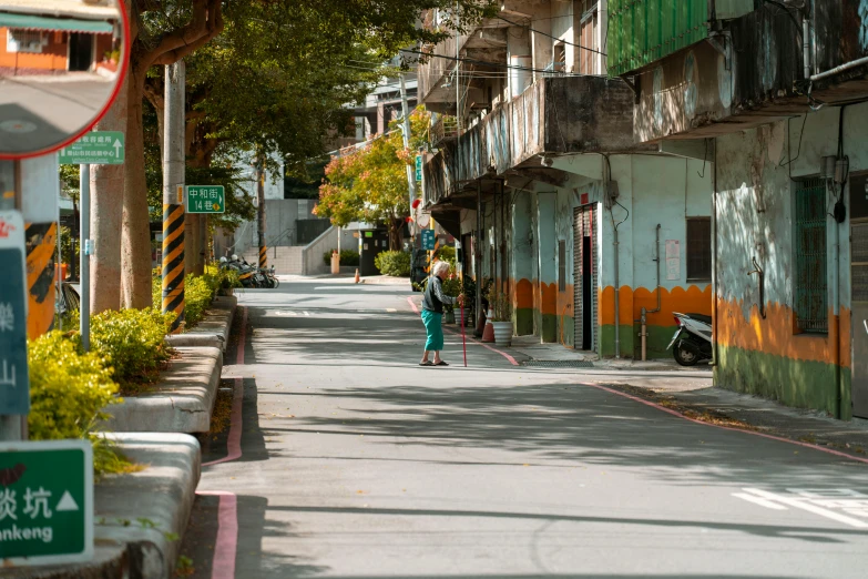 a woman standing on a sidewalk in front of some buildings