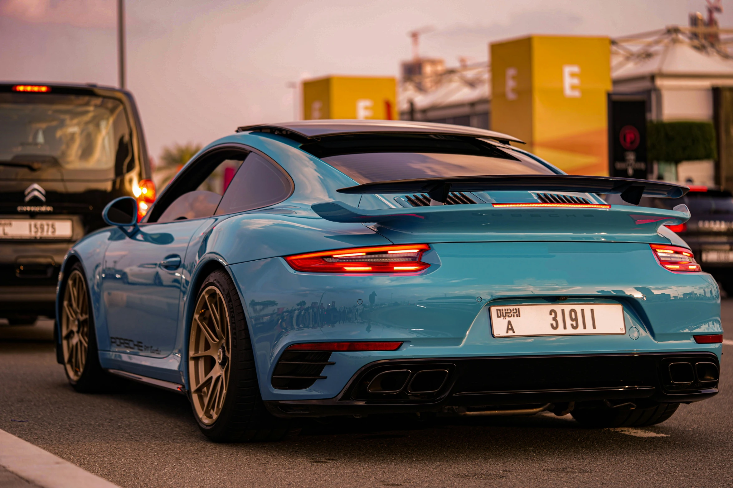 a blue sports car is parked on the street