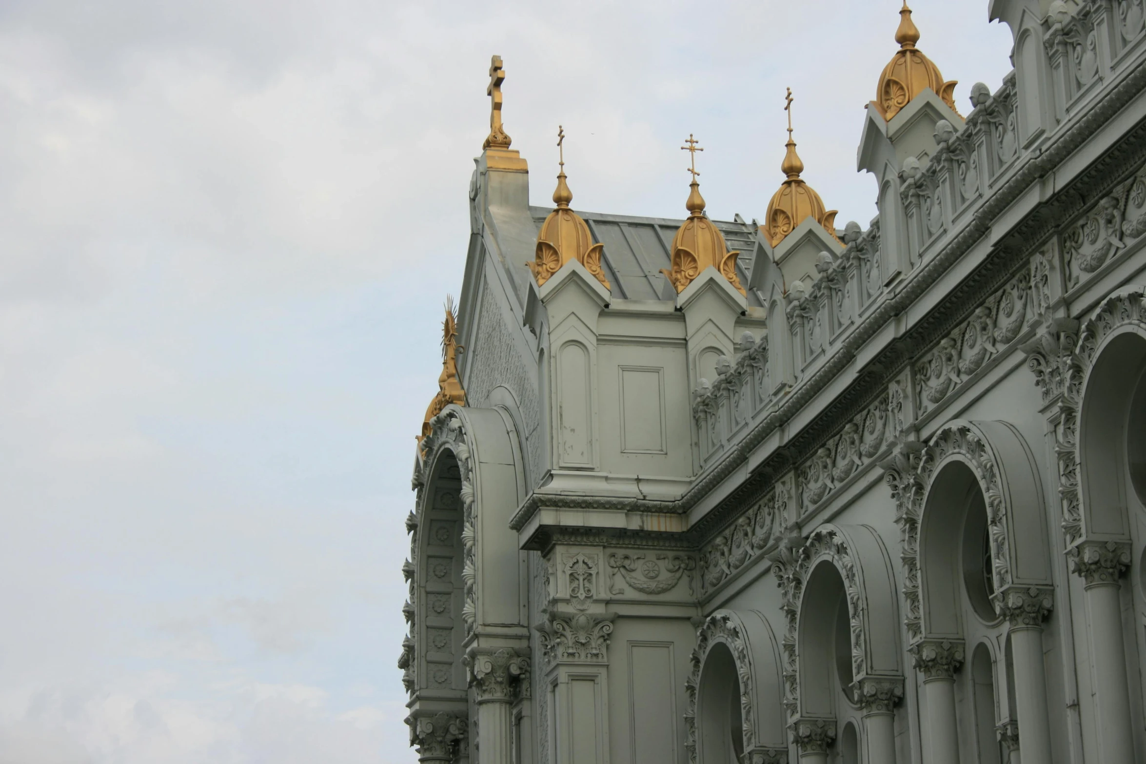 a large building with a tall tower and some gold domes