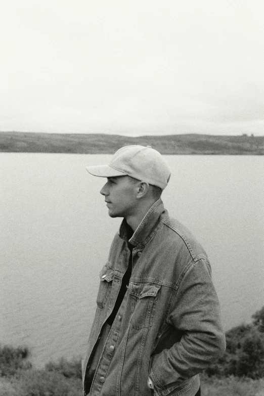 a man standing next to a body of water