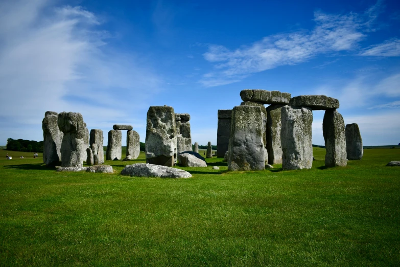 an ancient monument stands on a large grassy area