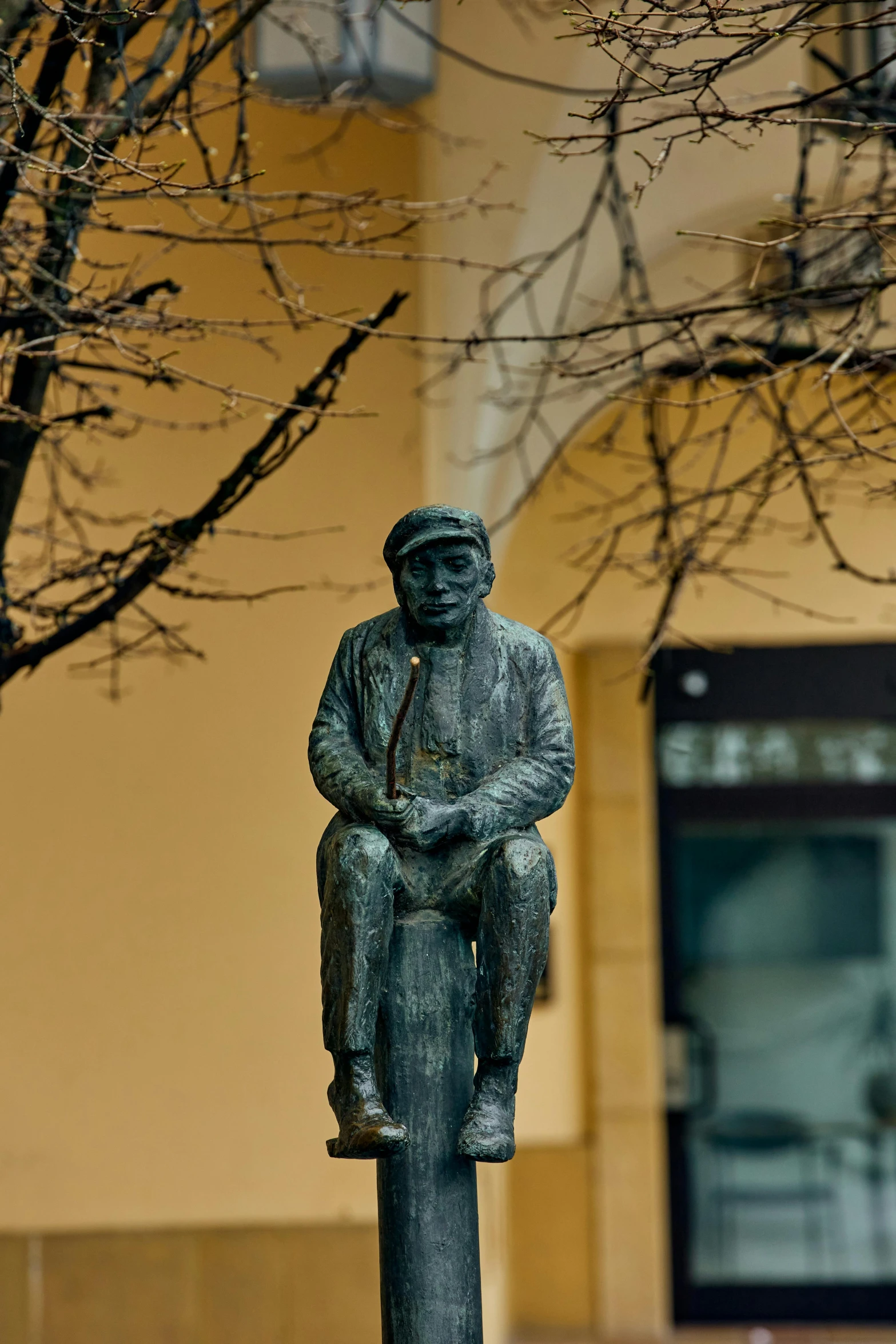 a statue is sitting on top of a pole