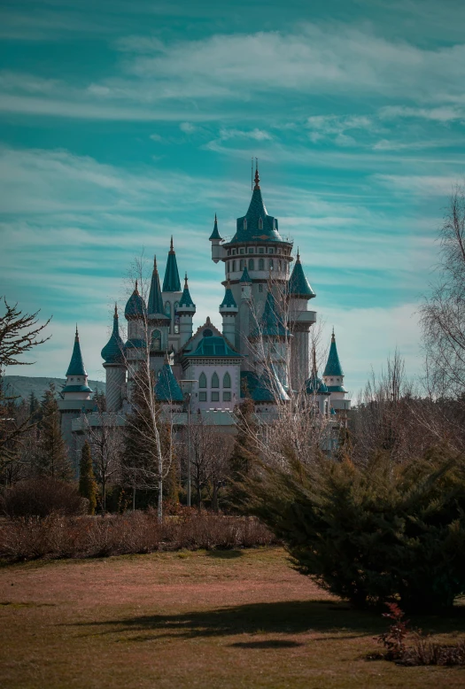 a beautiful castle that has a clock displayed on it