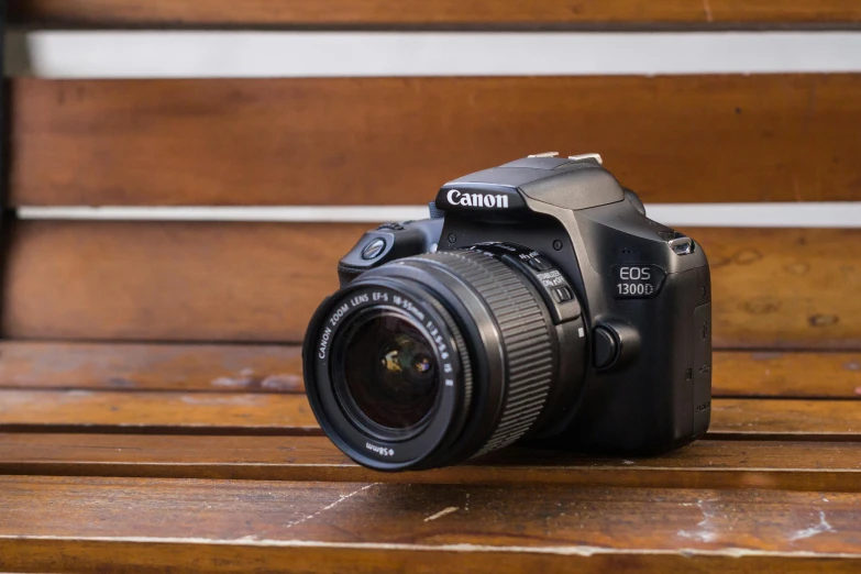 a camera sitting on top of a wooden bench